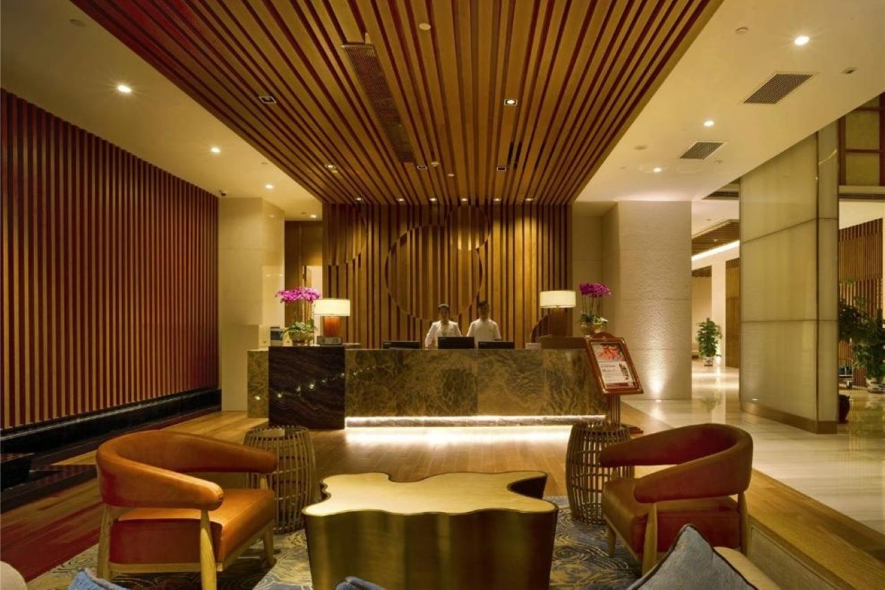 Happiora reception desk with stone walls and personal welcome